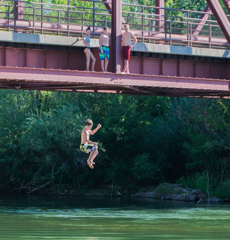 Work being done on Whitewater Park's wave, and a few kids jumping off the bridge in Boise, Idaho. Photos by Terry Welch.