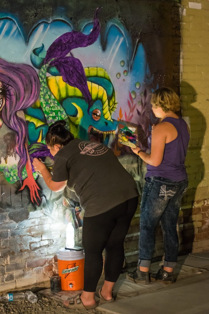 Pictures of people painting on the walls of Freak Alley on August 12th, 2017. Photos by Terry Welch.