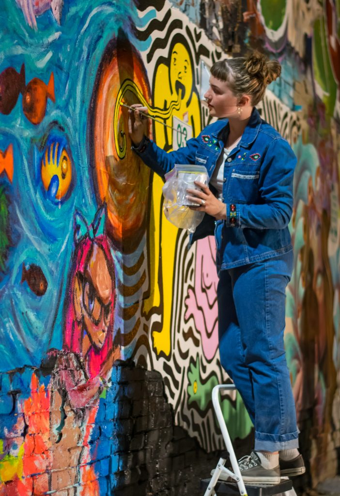 Pictures of people painting on the walls of Freak Alley on August 12th, 2017. Photos by Terry Welch.